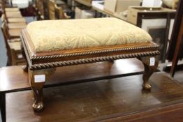 A small upholstered stool.