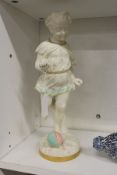 A unusual Royal Worcester part glazed figure of a young girl about to kick a ball.