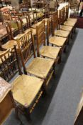 A matched set of eight 19th century Lancashire spindle back rush seated ash dining chairs.