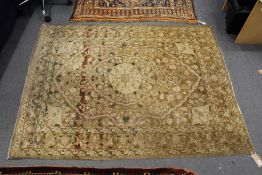 A Persian Tabriz rug, beige ground with floral decoration.