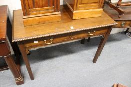 A George III style mahogany two drawer side table on square legs.