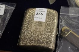 An engraved silver cigarette case.