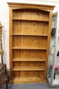 A tall pine open book case.