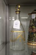 A Georgian gilt decorated mallet shaped cut glass decanter and stopper.