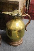 A copper and brass lidded jug.