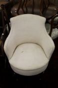 A cream upholstered Edwardian bedroom chair.