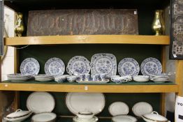 A quantity of blue and white onion pattern china.