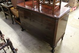 A three drawer chest on carved cabriole legs.