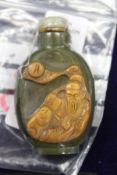 A Chinese carved jade snuff bottle.