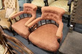 A pair of Victorian mahogany framed horseshoe shaped low open armchairs.