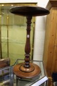 A mahogany circular occasional table on column supports with circular base.
