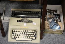An Olivetti Lettera 25 typewriter and a box of shoe trees.