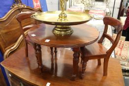 A miniature Victorian style mahogany circular table and a pair of chairs.