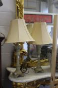 A pair of ornate cast metal table lamps.