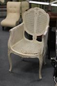 A French style white painted Bergere armchair (AF).