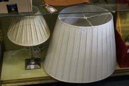 A table lamp and a large lampshade.