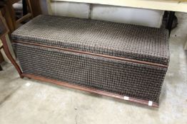 An upholstered box ottoman.