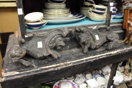 A pair of cast metal lion shaped fire dogs.
