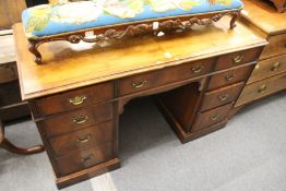 A walnut pedestal desk.