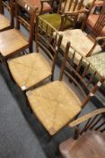 A pair of rush seated spindle back occasional chairs.