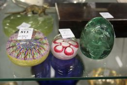 Three glass paperweights.