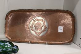 An unusual copper rounded rectangular tray with inlaid decoration, monogrammed.