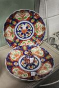 A pair of Japanese Imari dishes and similar small bud vase.