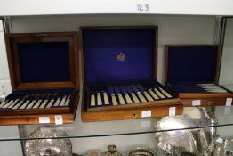 Two mahogany cased sets of mother-of-pearl handled dessert knives and forks together with a cased