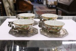 A set of four Chinese famille rose porcelan and silver mounted cups and saucers.