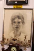 A portrait bust of a young girl, charcoal, signed and dated.