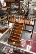 A miniature mahogany set of steps leading to a balcony.