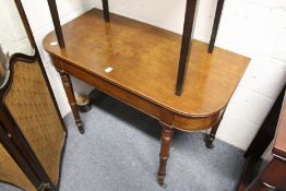 A mahogany D-shaped side table on turned legs.