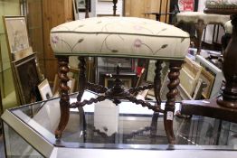 A good small upholstered stool on barley twist legs and stretchers.