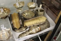 A silver hand mirror, a pair of brushes, a cream jug etc.