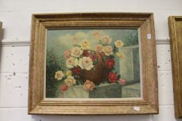 A still life of roses in a basket, oil on canvas, signed, in a decorative gilt frame.