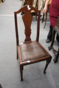 A set of four mahogany high back dining chairs.