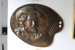 An unusual embossed copper plaque, modelled as an artist's palette.