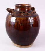 A CHINESE TREACE GLAZED POTTERY EWER, possibly Song dynasty, with moulded handle and spout, 26cm.