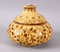 A CREAM GLAZED POTTERY HUQQA BASE, painted with stylised flowers, 13cm high.