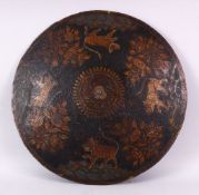 A FINE 18TH/19TH CENTURY INDIAN PAINTED LACQUER LEATHER SHIELD, decorated with a band of tigers,