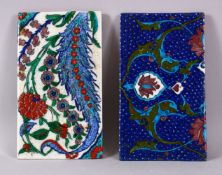 TWO IZNIK DECORATED PORCELAIN FRAGMENT TILES, one with ablue ground, the other with white, both with