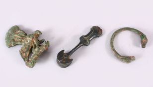 AN EARLY PERSIAN BRONZE ZOOMORPHIC AXE HEAD, together with bangle and dagger handle, axe 12cm high.