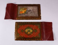 A KHATIMI LACQUER BOOK COVER in two parts, the upper part with engraved silver panel, 25cm x 17cm.
