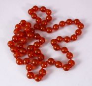 A 19TH CENTURY SET OF CARVED AMBER PRAYER BEADS, in the form of a necklace, comprising 50