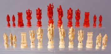 AN EARLY 20TH CENTURY IVORY AND STAINED IVORY INDIAN CHESS SET, carved as Indian gods and temples,