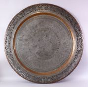 A MONUMENTAL INDIAN ENGRAVED METAL TRAY, with pierced border, 98cm diameter.
