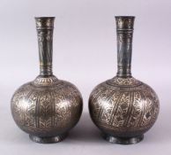 A PAIR OF 18TH/19TH CENTURY INDIAN BIDRI SILVER INLAID BOTTLES, 26cm high.