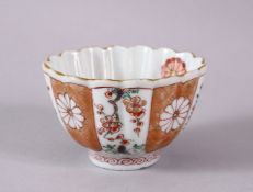 A CHINESE KANGXI PERIOD FAMILLE VERTE PORCELAIN FLUTED TEA BOWL, with decoration of prunus and