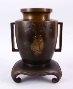 A JAPANESE MEIJI PERIOD BRONZE & MIXED METAL INLAID VASE & STAND with decoration of two figures in a
