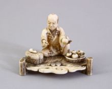 A GOOD JAPANESE MEIJI PERIOD CARVED IVORY OKIMONO, the okimono carved to depict a seated fruit